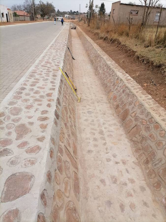 Hand-packed stone pitched side channel