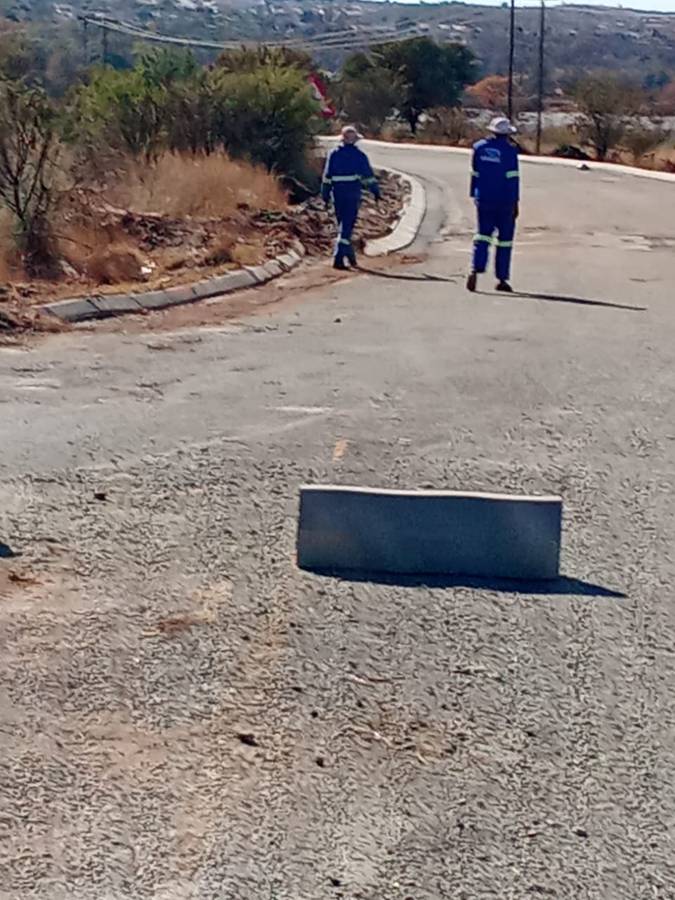 Approach road with kerbing and channel